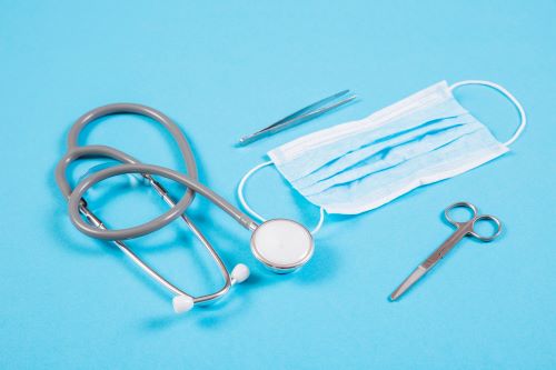 stethoscope-surgical-mask-scissor-tweezers-colored-background_23-2147874852